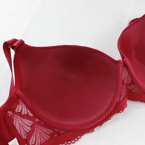 Close-up detail of smooth inner lining and delicate red floral lace on a full cup bra