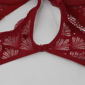 Macro detail of intricate floral lace patterns on a sexy red full cup bra