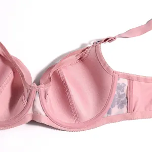 Close-up detail of the breathable interior lining and floral lace on a pink bra