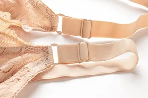 Close-up detail showing the adjustable elastic straps of a nude floral lace plus size bra