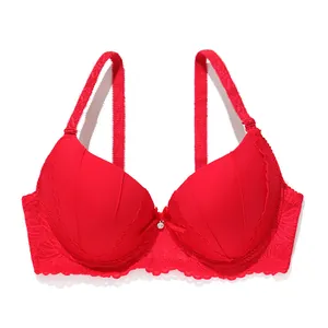 Detailed view of a bright red push-up bra with delicate lace trim and a small center bow.