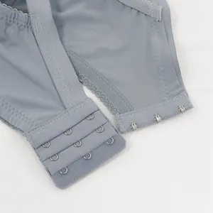 Detalle del cierre de 3 filas de corchetes en un sujetador de encaje azul claro talla grande.