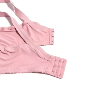 Detailed view of the pink bra back closure featuring a three-row hook and eye design