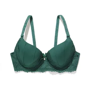 Detail showing the intricate lace trim and center bow on a dark green push-up bra.