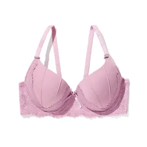 Detail view of pink push-up bra featuring delicate lace trim and central bow ornament