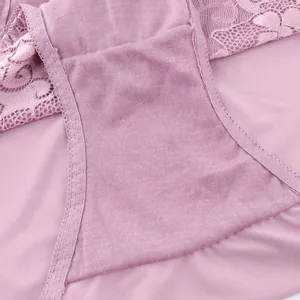 Macro detail of plus size pink lace panties showing breathable cotton lining and floral lace