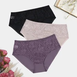 Detailed view of three pairs of women's lace panties in black, nude, and purple