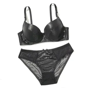 Detailed view of a sexy black PU leather bra set featuring sheer lace mesh panties.