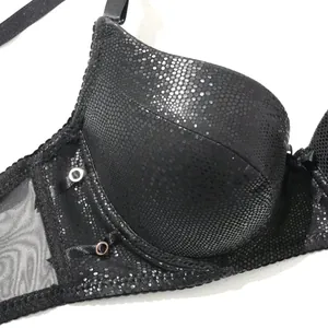 Macro detail shot of black PU leather bra featuring honeycomb texture and sheer mesh side