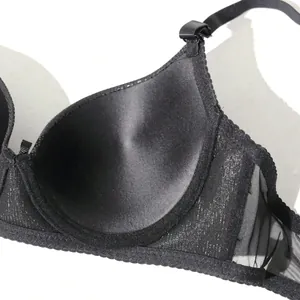 Macro view of a sexy black PU leather push-up bra featuring delicate mesh details