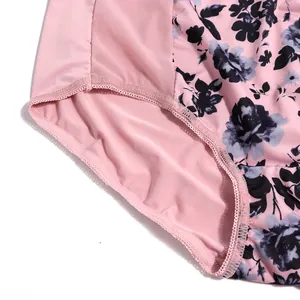 Close-up detail of plus size floral print panties with pink mesh fabric texture.