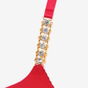 Close-up of red push-up bra featuring a luxurious gold chain strap with sparkling rhinestones.