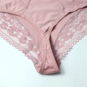 Close-up detail of dusty pink cotton panties with elegant scalloped lace edges