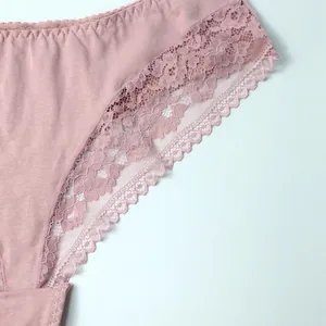Macro view showing the intricate floral lace edge and soft cotton fabric of these dusty pink panties