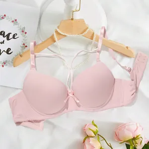 Close-up of a pink push-up bra featuring a smooth surface and front lace-up detail