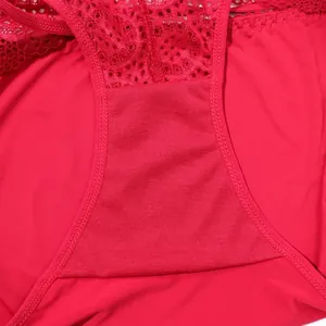 Close-up macro view of the breathable cotton crotch lining on red lace panties