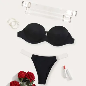 Detail view of black strapless bra set with detachable clear straps and matching thong.