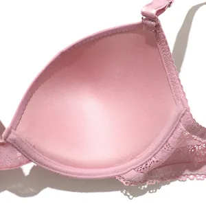 Macro detail of pink push-up bra featuring soft inner lining and delicate lace trim.