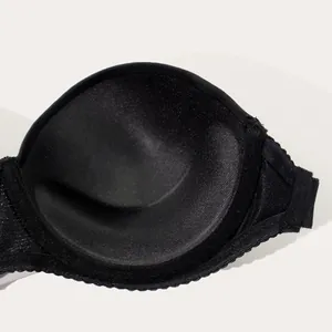 Detailed interior view of a seamless black bra cup showing soft and comfortable padding texture