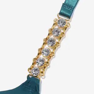 Detailed macro view of sparkling rhinestone metal chain on deep teal bra strap accessory