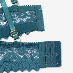 Detail view of dark green floral lace bra showing back hooks and adjustable shoulder straps