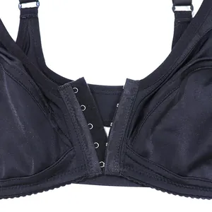Close-up detail showing the multi-hook front closure on a seamless black wireless bra.