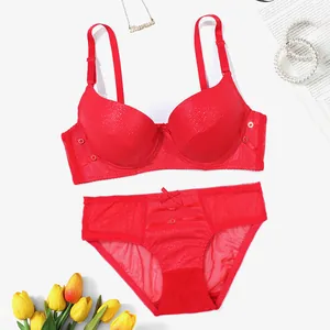 Detailed view of sexy red PU leather push-up bra and sheer mesh panty set