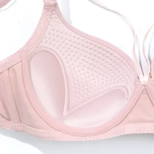Close-up of pink push-up bra interior padding with massage texture details.