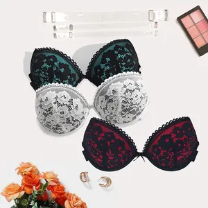 Detail view of lace push-up bras in three colors with transparent straps for party wear.