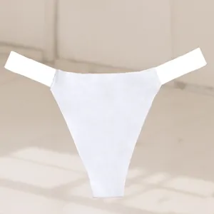 Detail of white seamless thong with transparent elastic side straps for women.