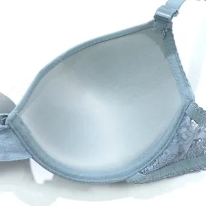 Macro view of soft inner lining and elegant floral lace detail on a light blue bra