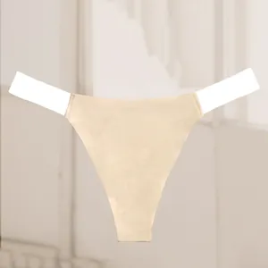 Close-up detail of seamless beige thong featuring invisible transparent waist straps.