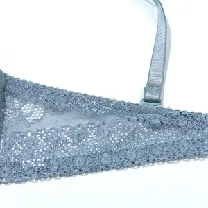 Detailed close-up of intricate light blue floral lace on a push-up bra wing.