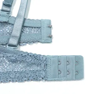 Close-up of light blue lace bra back closure with double row hook-and-eye
