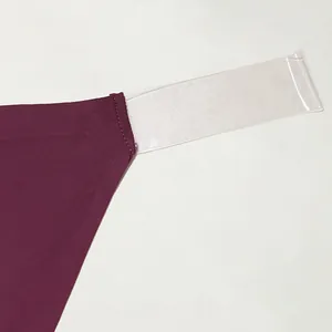Detail showing the seamless junction of burgundy thong and clear transparent strap.