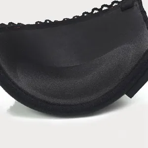 Close-up macro detail showing the soft padded interior of a sexy black lace bra cup.