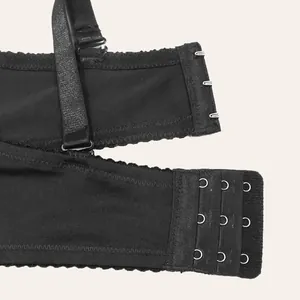 Close-up of black bra back closure with three-row hooks and adjustable strap