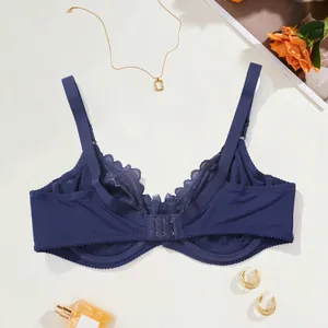 Detail view of the lace bra's back hook closure and breathable interior fabric