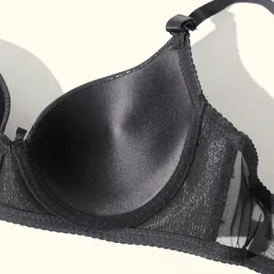 Detailed view of a black push-up bra with satin texture and detachable straps.