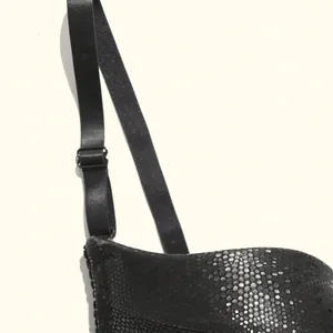 Close-up detail of black PU leather bra showing snakeskin texture and adjustable strap
