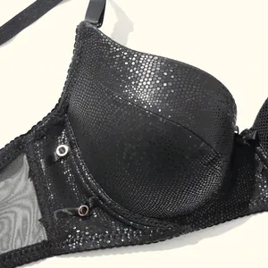 Close-up of black PU leather bra featuring a metallic scale texture and grommet detail.