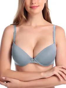 Detail of a gray lace bra featuring a center bow, thin molded cups, and supportive underwire.