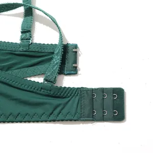 Macro view of dark green lingerie bra showing details of three-row hook and eye closure