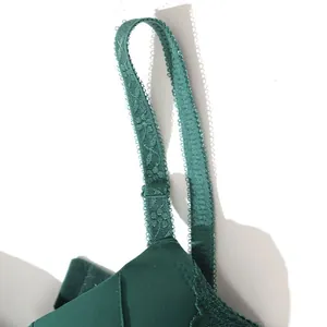 Close-up view of dark green adjustable lace shoulder strap detail on comfortable push-up bra