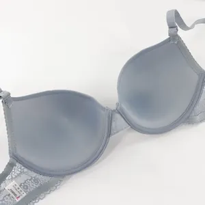 Detail shot of a light blue lace bra featuring thin mold cups and detachable straps