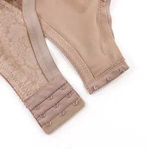 Close-up of the adjustable three-row hook-and-eye closure and lace band of the nude bra.