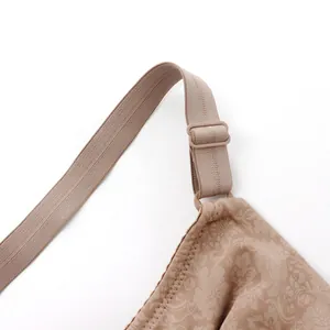 Close-up detail of adjustable strap and floral pattern on a full cup beige bra.