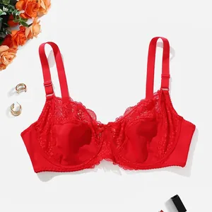 Detailed view of a sexy red lace full cup bra with underwire, styled with floral props