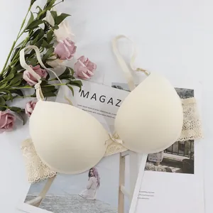 Elegant beige lace bra with center bow detail and adjustable straps