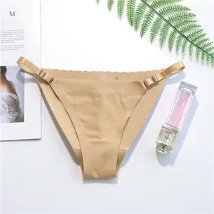 Detailed view of seamless beige thong with adjustable side straps on white background